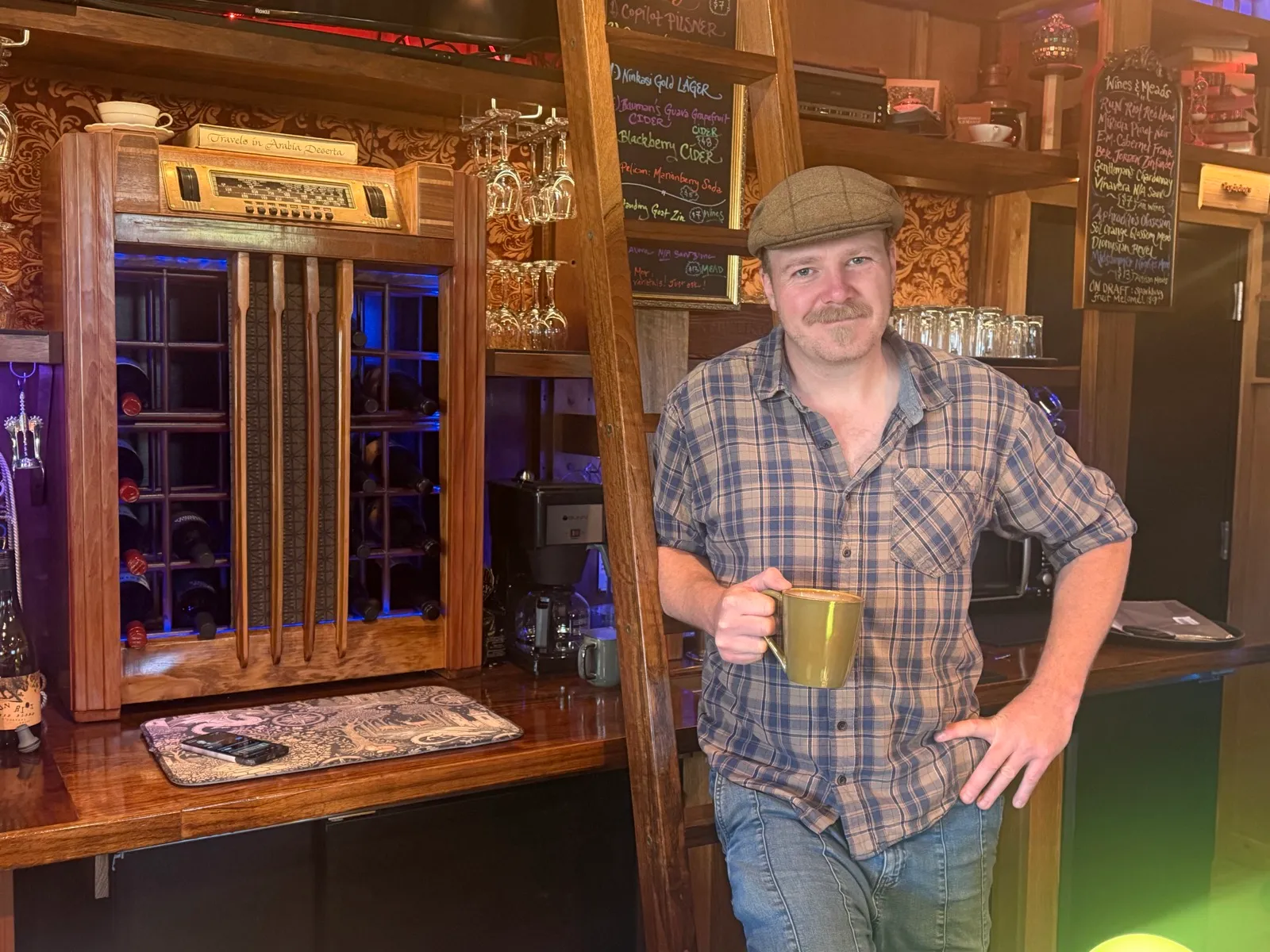 Jordan Mackay, proprietor, standing behind the bar at Our Third Space in Veneta, Oregon.